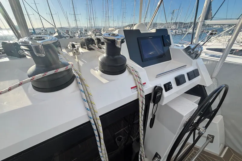  Yacht Photos Pics Helm of 2022 Leopard 42 catamaran with winches, ropes, and navigation controls.