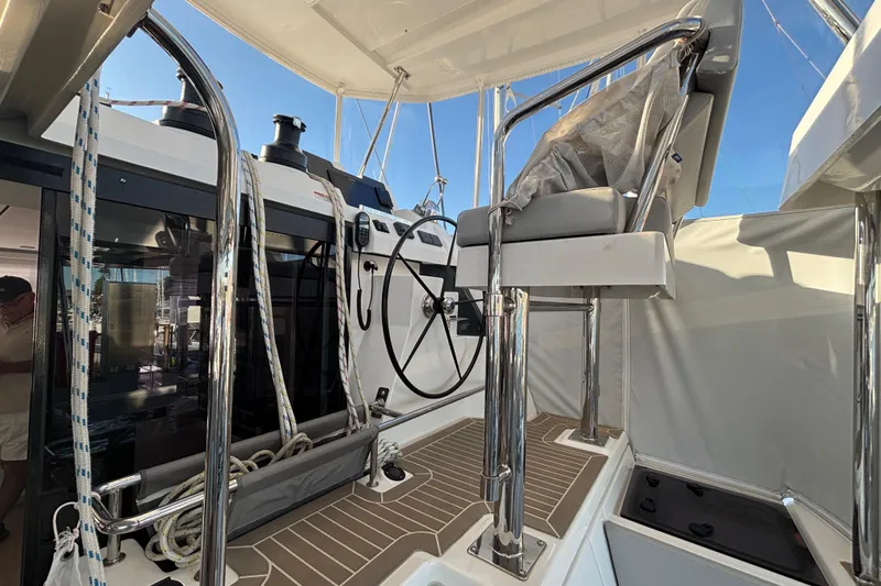  Yacht Photos Pics Helm station of 2022 Leopard 42 catamaran with steering wheel and seating.