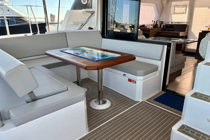  Yacht Photos Pics Interior of 2022 Leopard 42 yacht with modern seating and wooden table.
