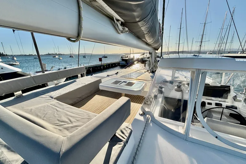  Yacht Photos Pics 2022 Leopard 42 catamaran deck with seating, docked at marina, sunny day.