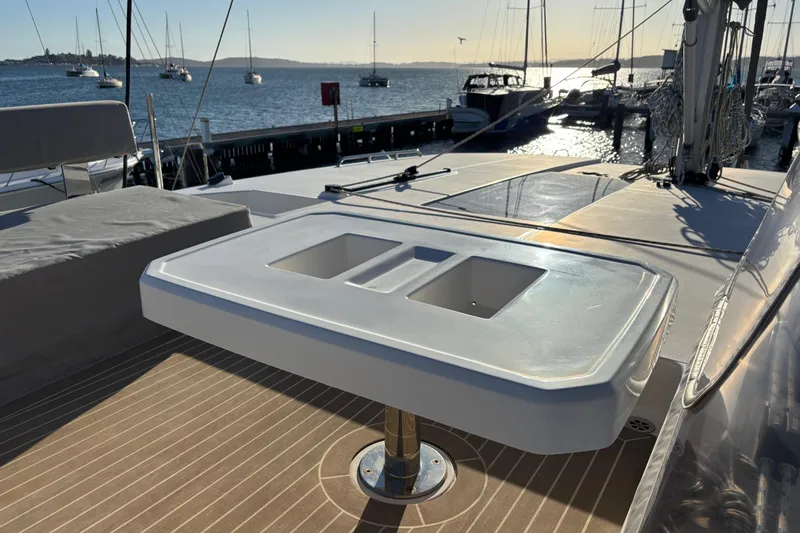  Yacht Photos Pics Leopard 42 catamaran deck with table, docked at marina, 2022 model.