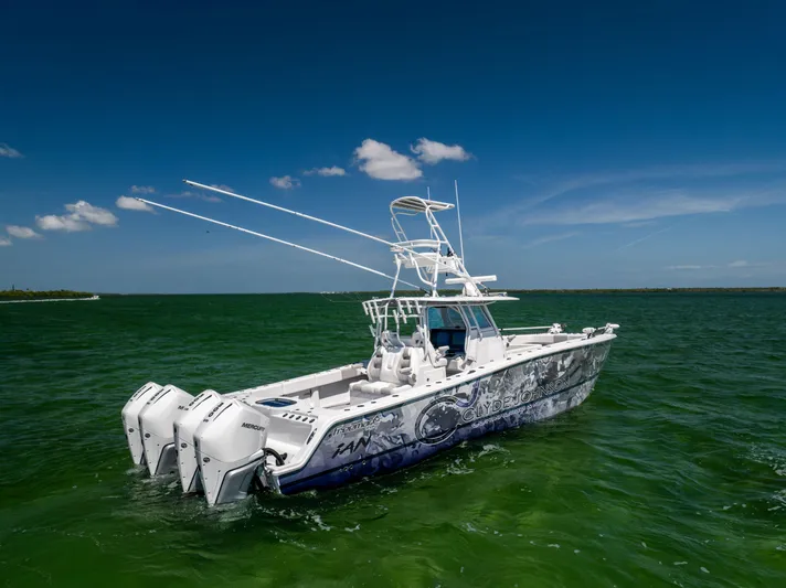  Yacht Photos Pics Freeman 37 VH 2023 boat with triple engines on green water under blue sky.