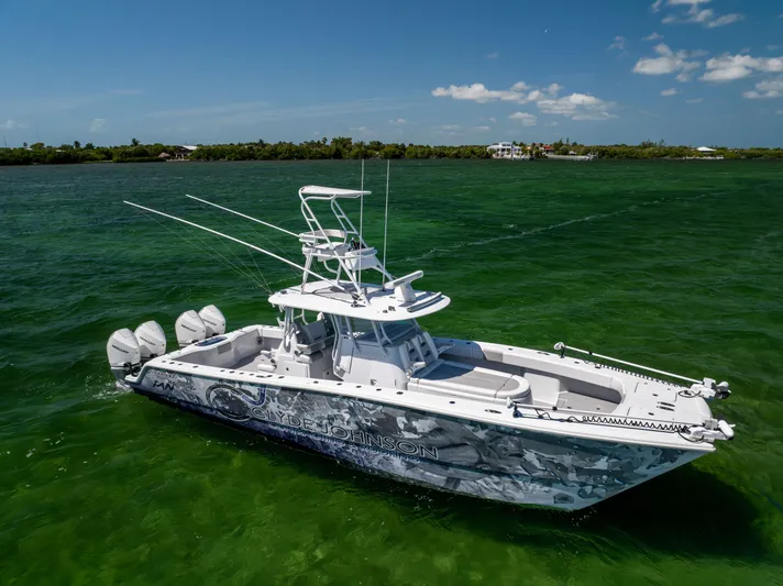  Yacht Photos Pics 2023 Freeman 37 VH boat on green water, clear sky background.