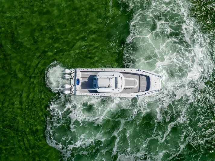  Yacht Photos Pics Aerial view of 2023 Freeman 37 VH boat navigating through green waters.