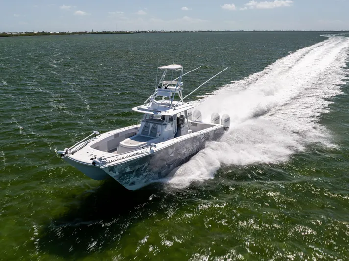  Yacht Photos Pics 2023 Freeman 37 VH boat speeding on open water, creating a dynamic wake.