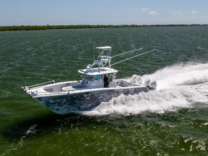  Yacht Photos Pics 2023 Freeman 37 VH boat speeding on open water, showcasing sleek design and powerful performance.