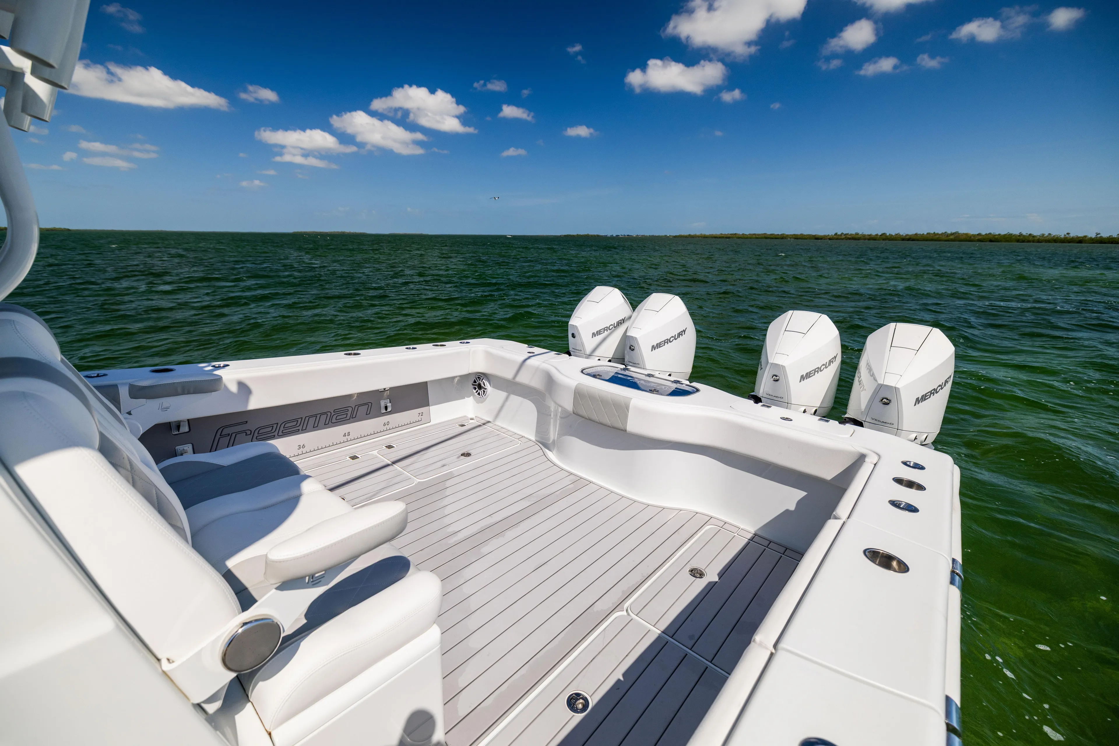  Yacht Photos Pics 2023 Freeman 37 VH boat with four engines on open water under blue sky.