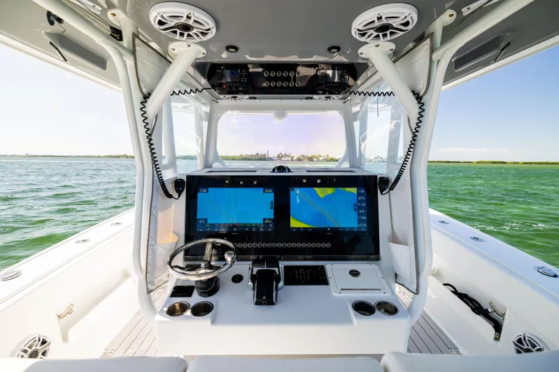  Yacht Photos Pics 2023 Freeman 37 VH boat cockpit with dual navigation screens on open water.