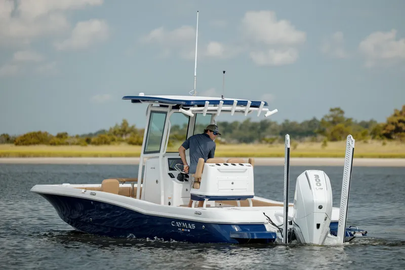  Yacht Photos Pics 2025 Caymas 26 HB boat cruising on a calm lake with a clear sky.