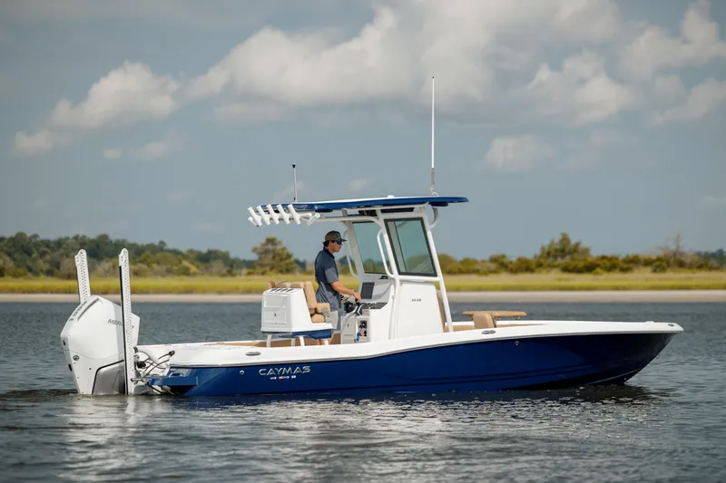  Yacht Photos Pics 2025 Caymas 26 HB boat cruising on calm water under a cloudy sky.