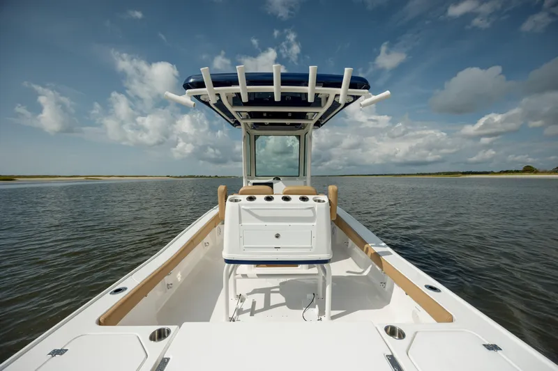  Yacht Photos Pics 2025 Caymas 26 HB boat on calm water under a cloudy sky.