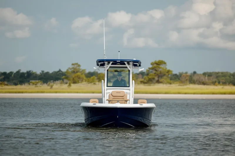  Yacht Photos Pics 2025 Caymas 26 HB boat cruising on calm water with scenic background.