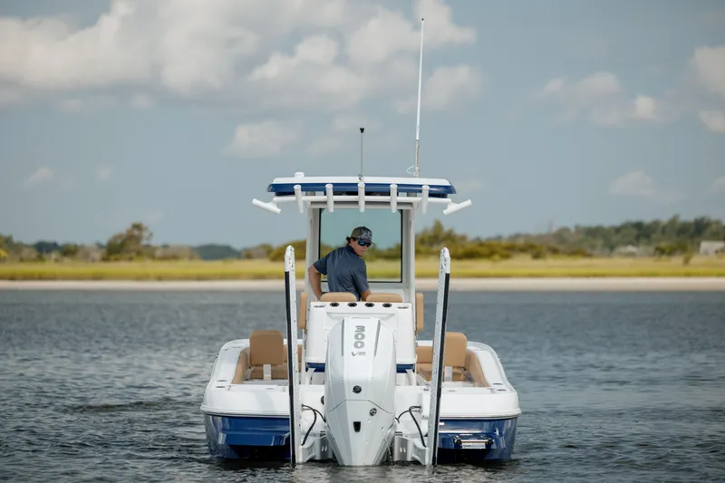 Yacht Photos Pics 2025 Caymas 26 HB boat on water, rear view with outboard motor.