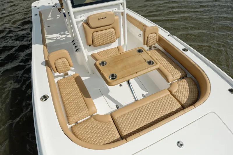  Yacht Photos Pics 2025 Caymas 26 HB boat interior with tan cushioned seating and table.