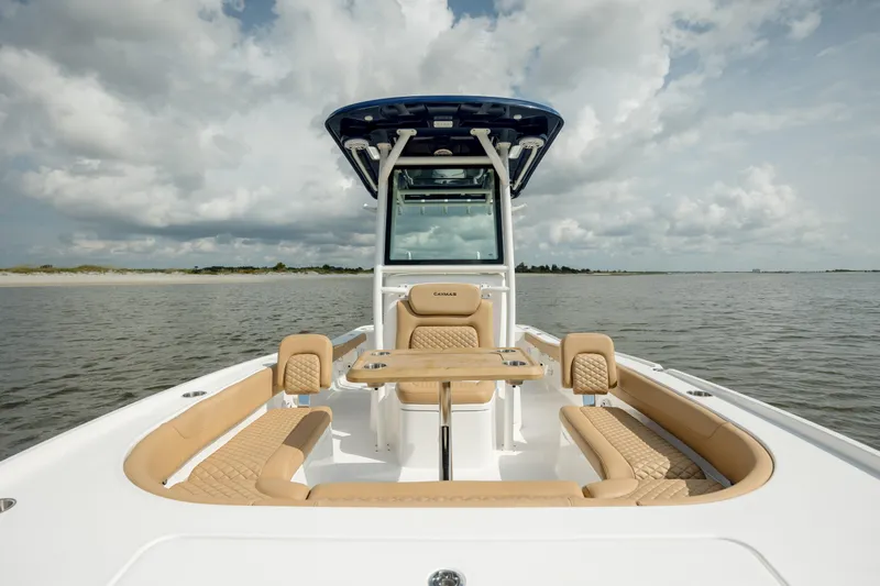  Yacht Photos Pics 2025 Caymas 26 HB boat on calm water under cloudy sky.