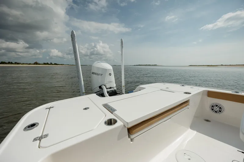  Yacht Photos Pics 2025 Caymas 26 HB boat on calm water, showcasing spacious deck and Mercury engine.