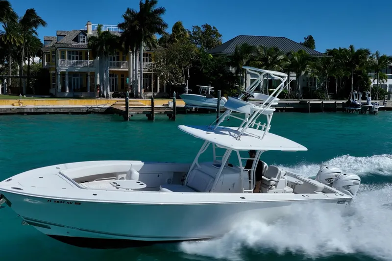  Yacht Photos Pics 2019 Jupiter 38 HFS boat cruising on turquoise water near luxury waterfront homes.