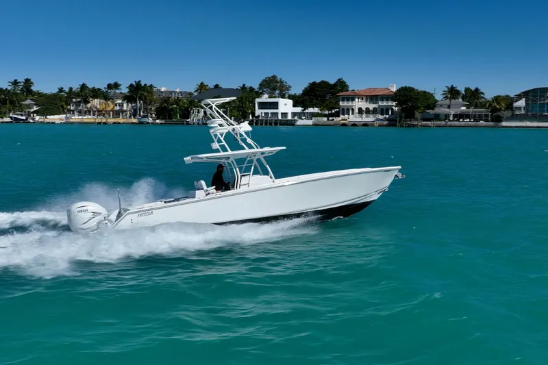  Yacht Photos Pics 2019 Jupiter 38 HFS boat cruising on turquoise water near luxury waterfront homes.