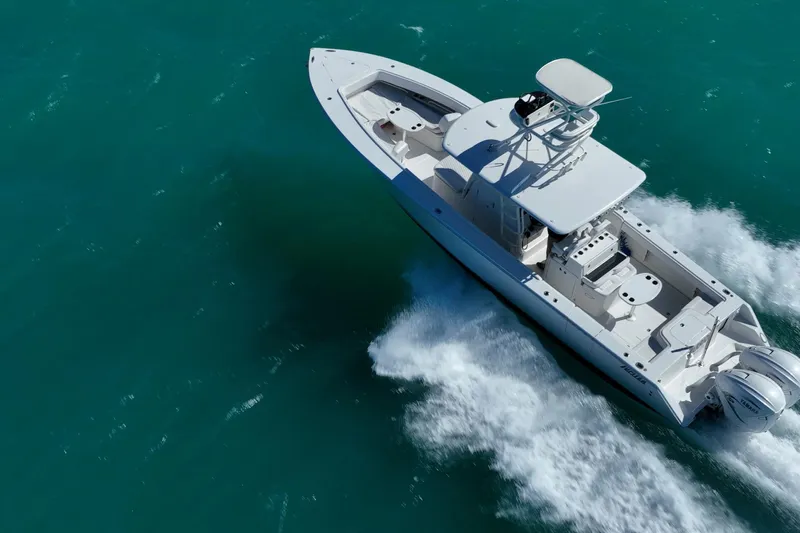  Yacht Photos Pics Aerial view of 2019 Jupiter 38 HFS boat cruising on turquoise water.