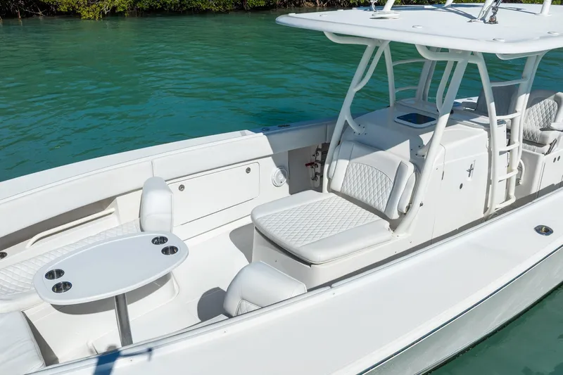 Yacht Photos Pics 2019 Jupiter 38 HFS boat interior with white seating and table on turquoise water.