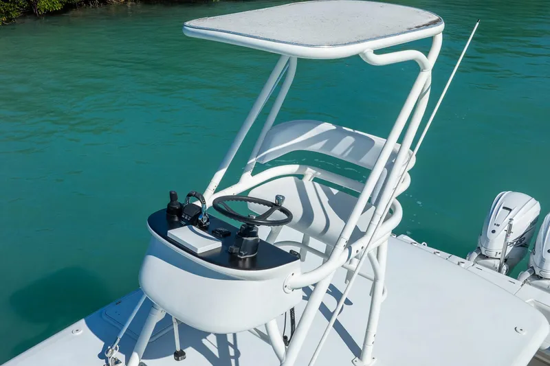  Yacht Photos Pics 2019 Jupiter 38 HFS boat helm station with controls, steering wheel, and canopy on turquoise water.