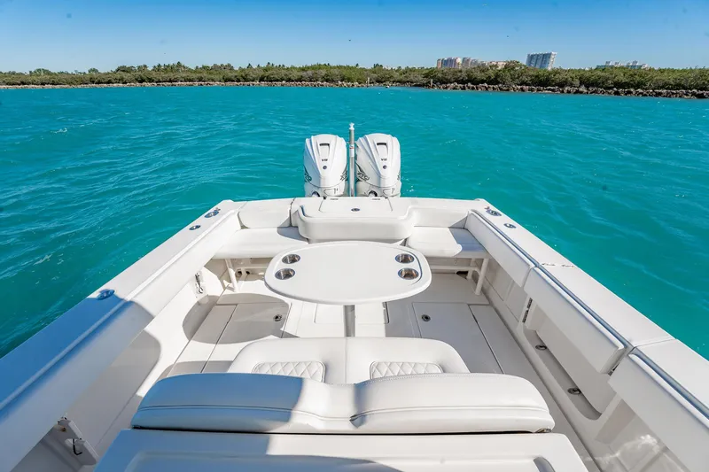  Yacht Photos Pics 2019 Jupiter 38 HFS boat on turquoise water, featuring spacious seating and dual engines.