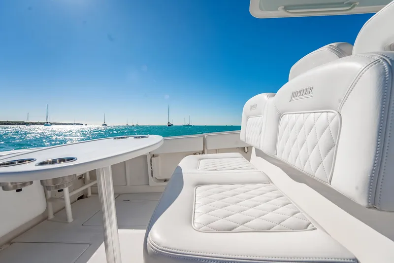  Yacht Photos Pics Luxurious seating on 2019 Jupiter 38 HFS boat with ocean view and clear blue sky.