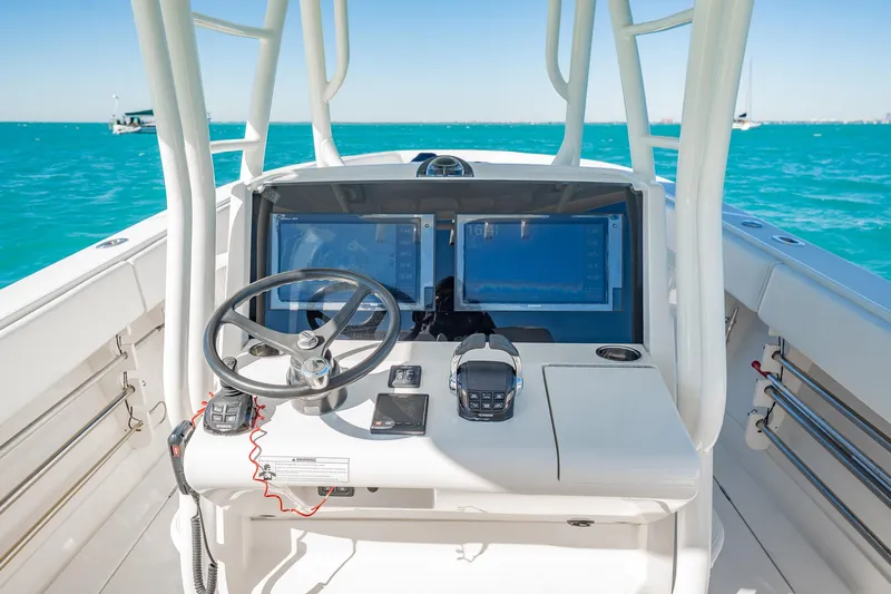  Yacht Photos Pics 2019 Jupiter 38 HFS boat cockpit with steering wheel and navigation screens on open water.