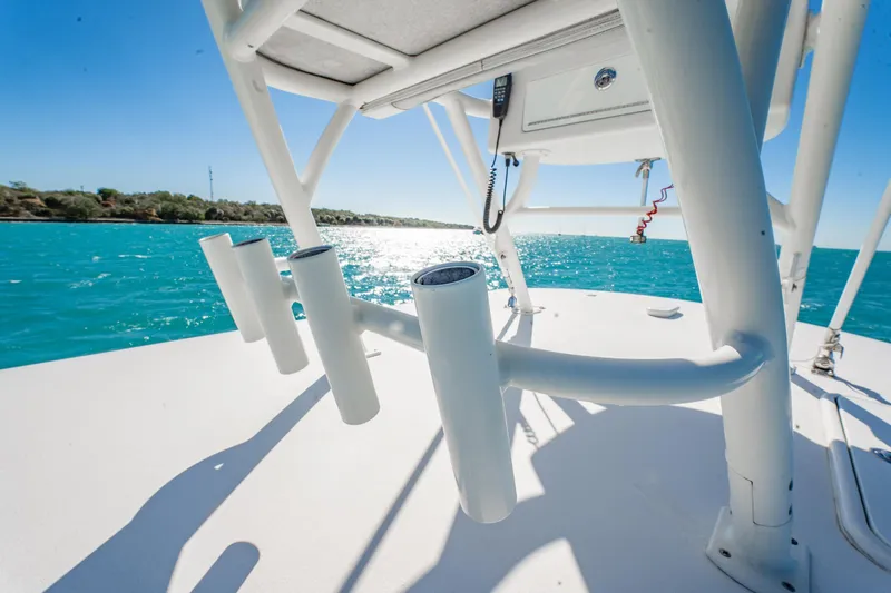  Yacht Photos Pics 2019 Jupiter 38 HFS boat on turquoise water, featuring rod holders and clear blue sky.