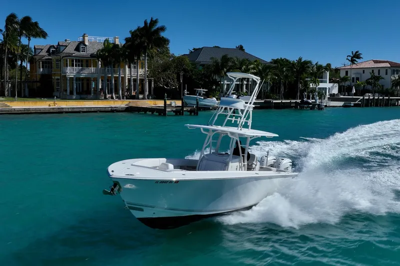  Yacht Photos Pics 2019 Jupiter 38 HFS boat cruising on turquoise water near luxury waterfront homes.