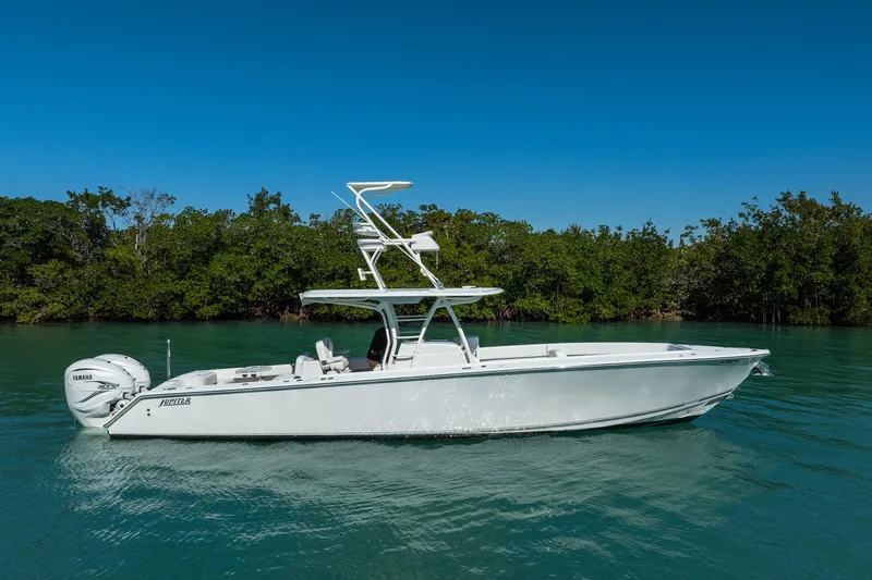  Yacht Photos Pics 2019 Jupiter 38 HFS boat on calm water with lush green background.