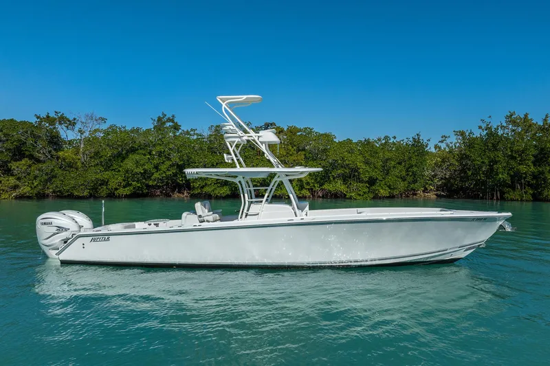 Yacht Photos Pics 2019 Jupiter 38 HFS boat on calm water with lush green background.