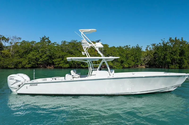  Yacht Photos Pics 2019 Jupiter 38 HFS boat on clear water with lush green background.
