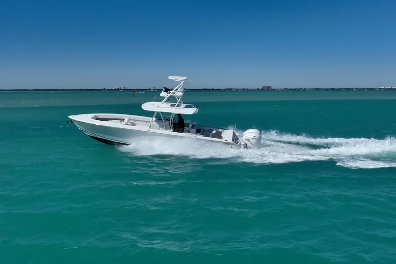  Yacht Photos Pics 2019 Jupiter 38 HFS boat cruising on turquoise water under clear blue sky.