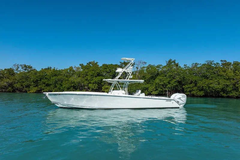  Yacht Photos Pics 2019 Jupiter 38 HFS boat on calm water with lush green trees in the background.