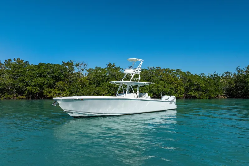  Yacht Photos Pics 2019 Jupiter 38 HFS boat on calm water with lush green trees in the background.
