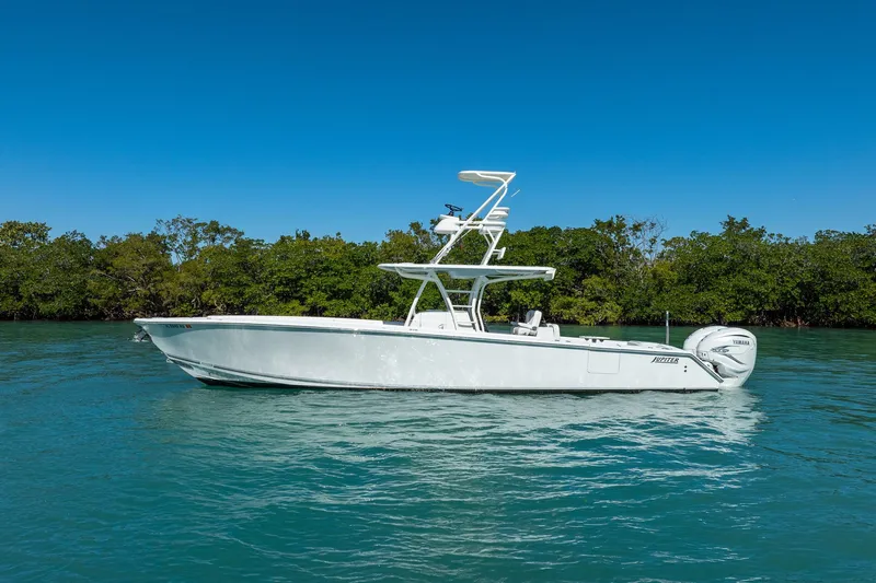  Yacht Photos Pics 2019 Jupiter 38 HFS boat on calm water with lush green background.