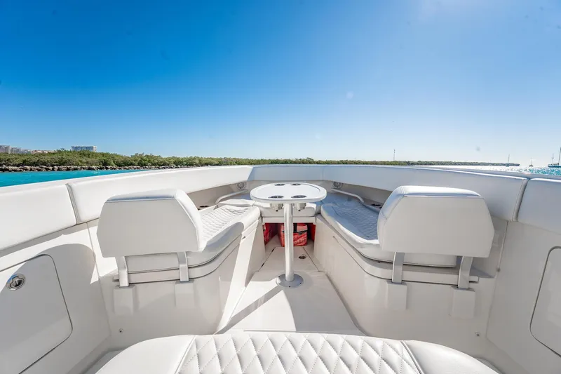  Yacht Photos Pics 2019 Jupiter 38 HFS boat interior with seating and table, under clear blue sky.