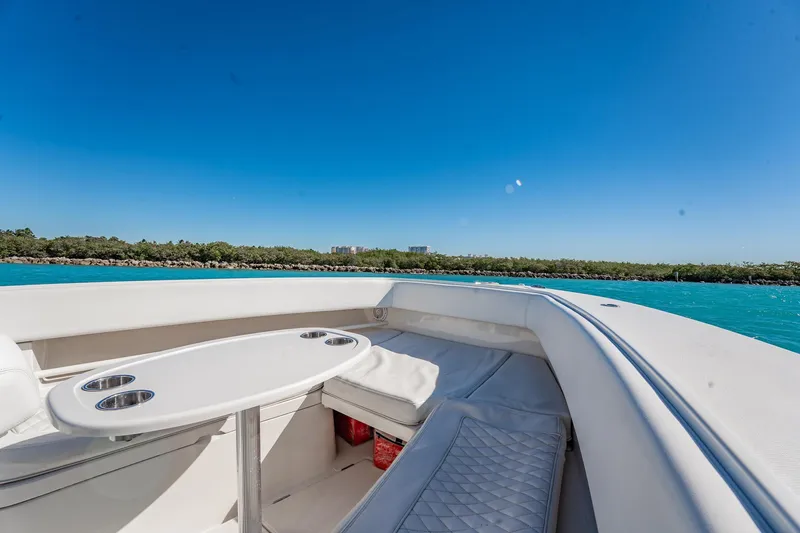  Yacht Photos Pics 2019 Jupiter 38 HFS boat interior with seating and table, cruising on clear blue water.