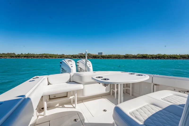  Yacht Photos Pics 2019 Jupiter 38 HFS boat interior with seating and table on turquoise water.