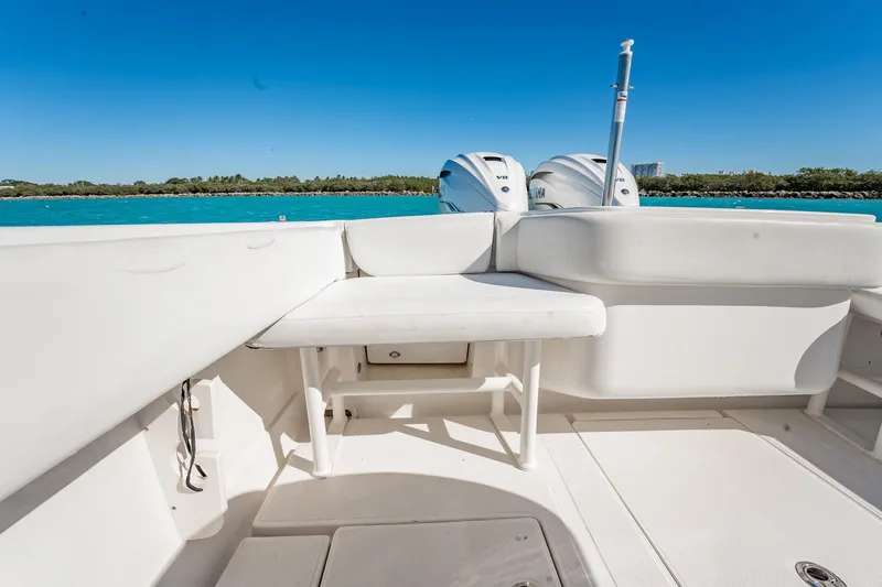  Yacht Photos Pics 2019 Jupiter 38 HFS boat interior with seating and dual engines, under clear blue sky.