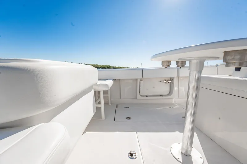  Yacht Photos Pics 2019 Jupiter 38 HFS boat interior with white seating and table under clear blue sky.