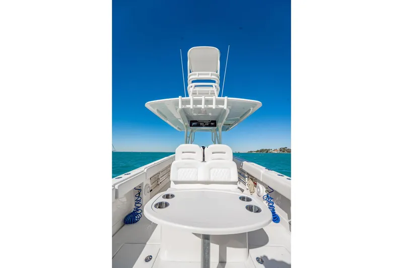  Yacht Photos Pics 2019 Jupiter 38 HFS boat interior with seating and table, under clear blue sky.