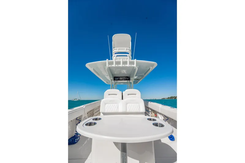  Yacht Photos Pics 2019 Jupiter 38 HFS boat interior with seating and table, under clear blue sky.