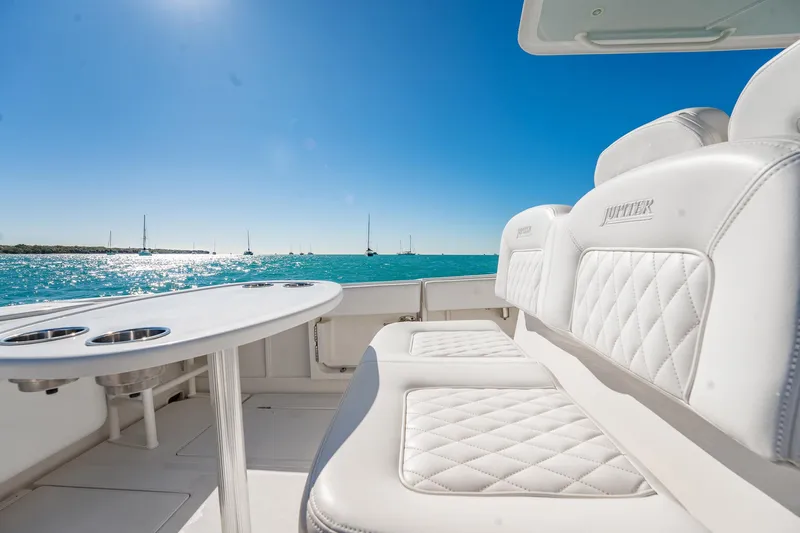  Yacht Photos Pics 2019 Jupiter 38 HFS boat interior with white seating, ocean view, and clear blue sky.