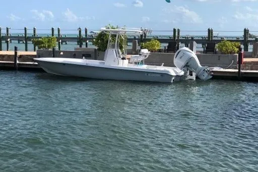  Yacht Photos Pics 2024 Contender 26 Bay boat docked in a marina with clear skies.