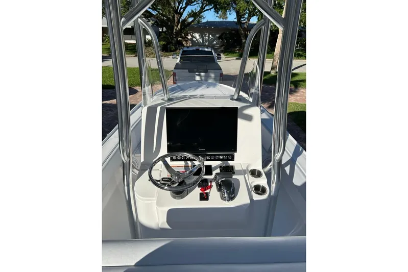  Yacht Photos Pics 2024 Contender 26 Bay boat console with steering wheel and controls.