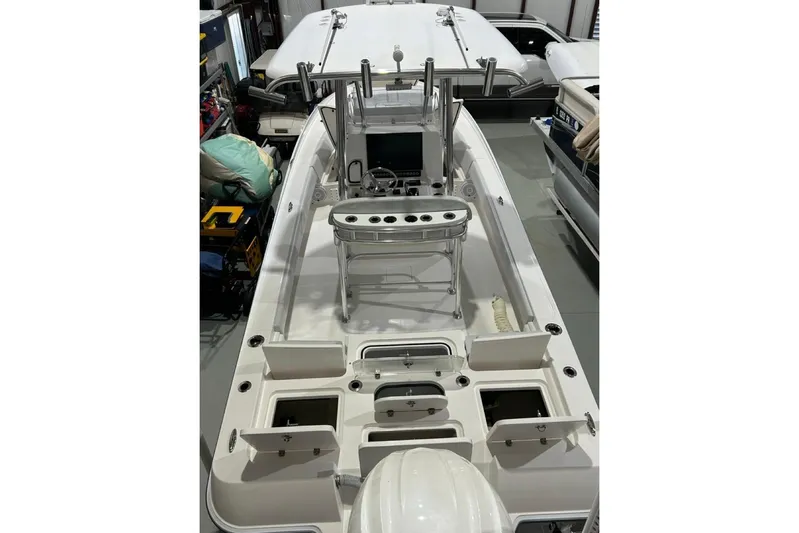  Yacht Photos Pics 2024 Contender 26 Bay boat interior with open storage compartments and helm station.