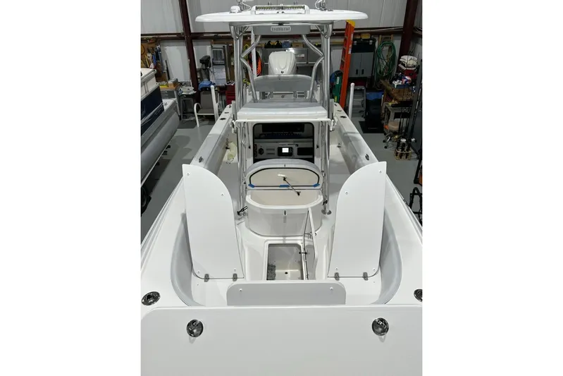  Yacht Photos Pics 2024 Contender 26 Bay boat interior with open hatches in a storage facility.