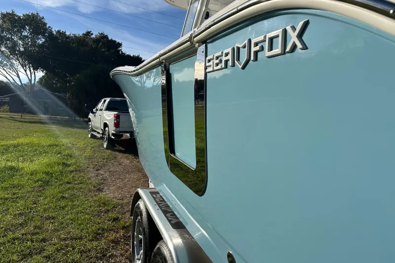  Yacht Photos Pics 2024 Sea Fox 288 Commander boat on trailer, parked beside a white truck.